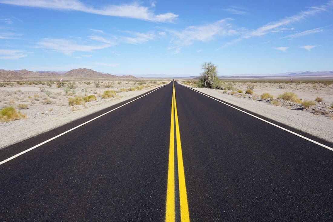 Picture of a road with double yellow lines in the middle.